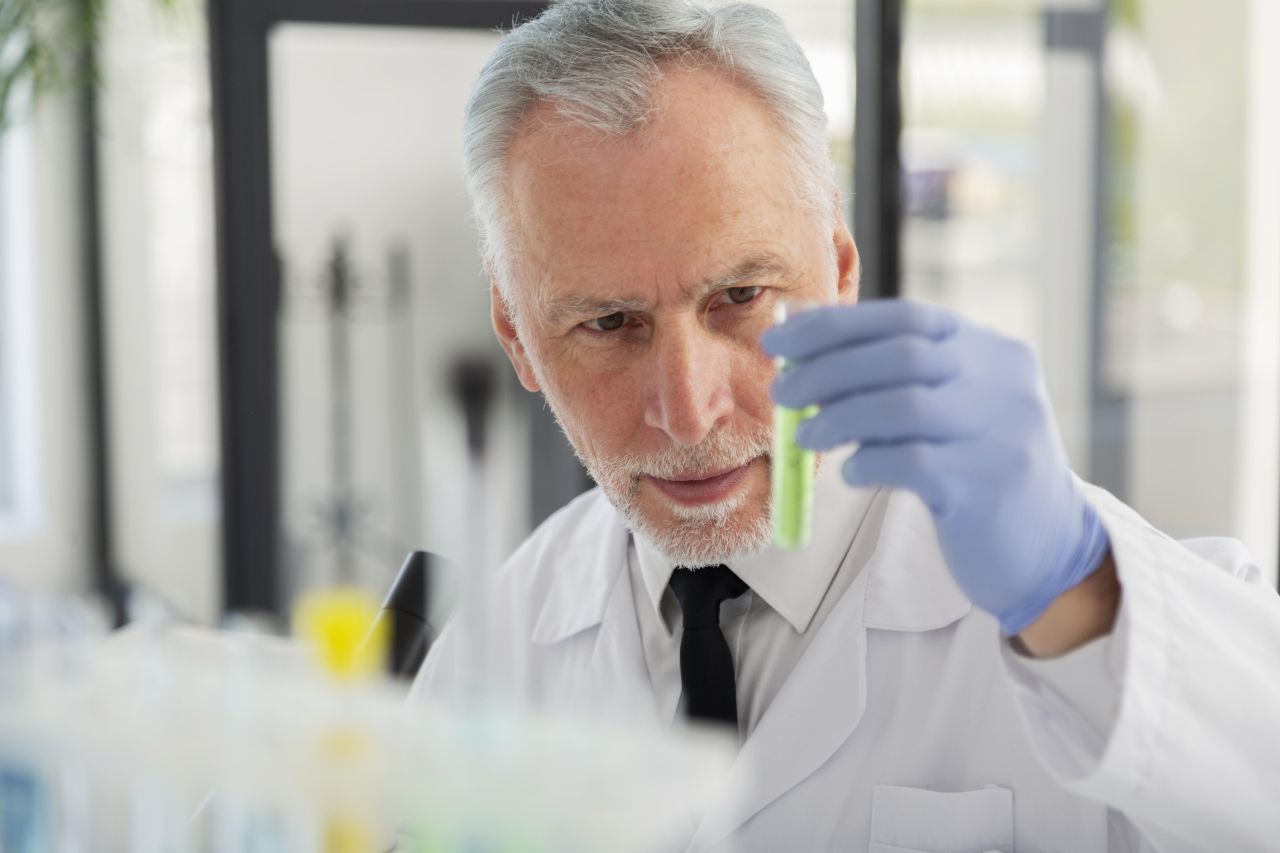 Close up scientist holding vial