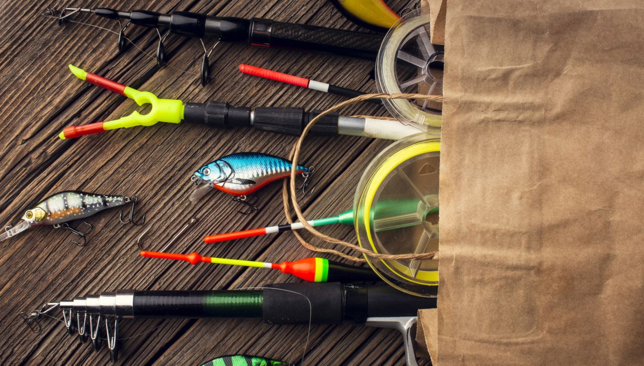 Top view of paper bag with fishing essentials